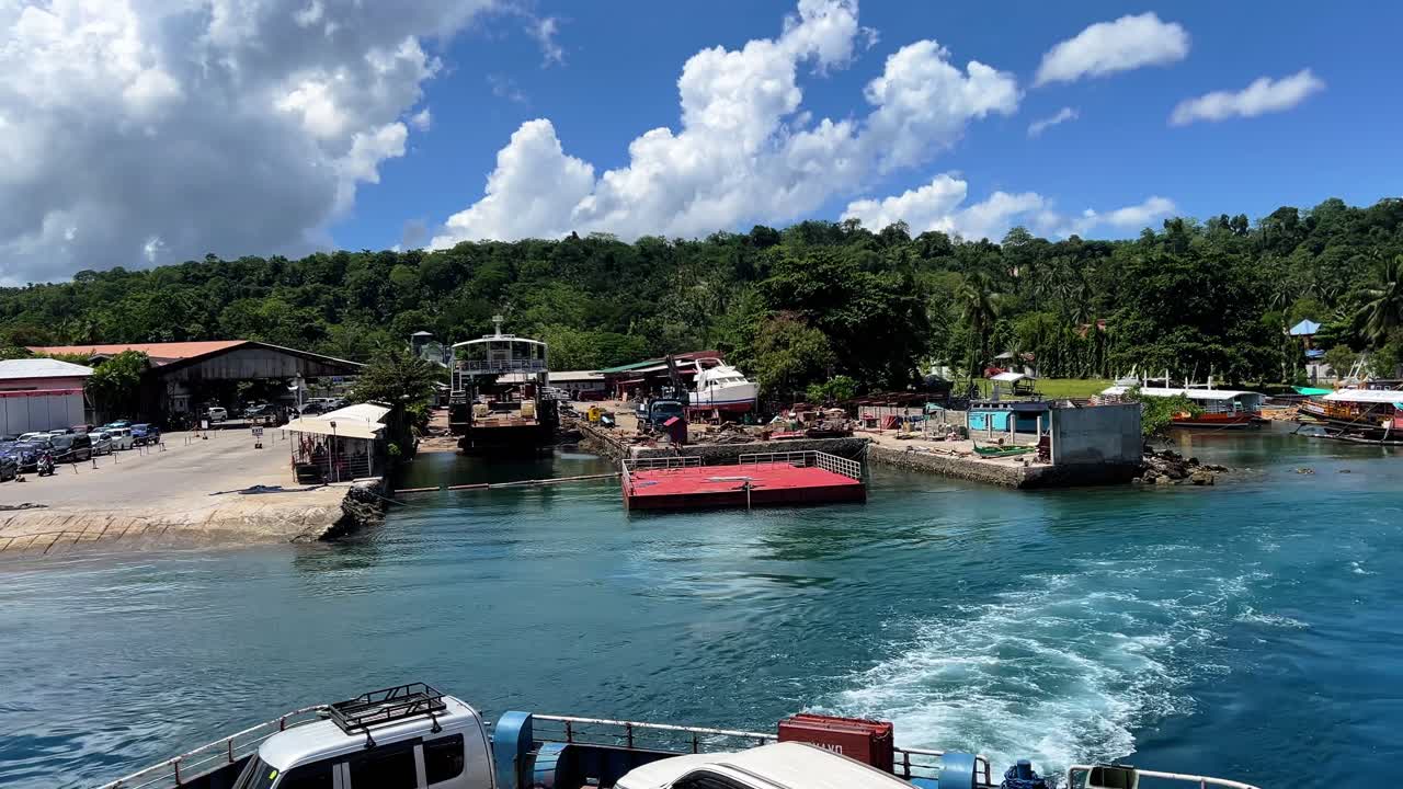 A vibrant boatyard and dock bustle with ferries and fishing boats in a lush tropical island setting—great for transport, lifestyle, and coastal visuals