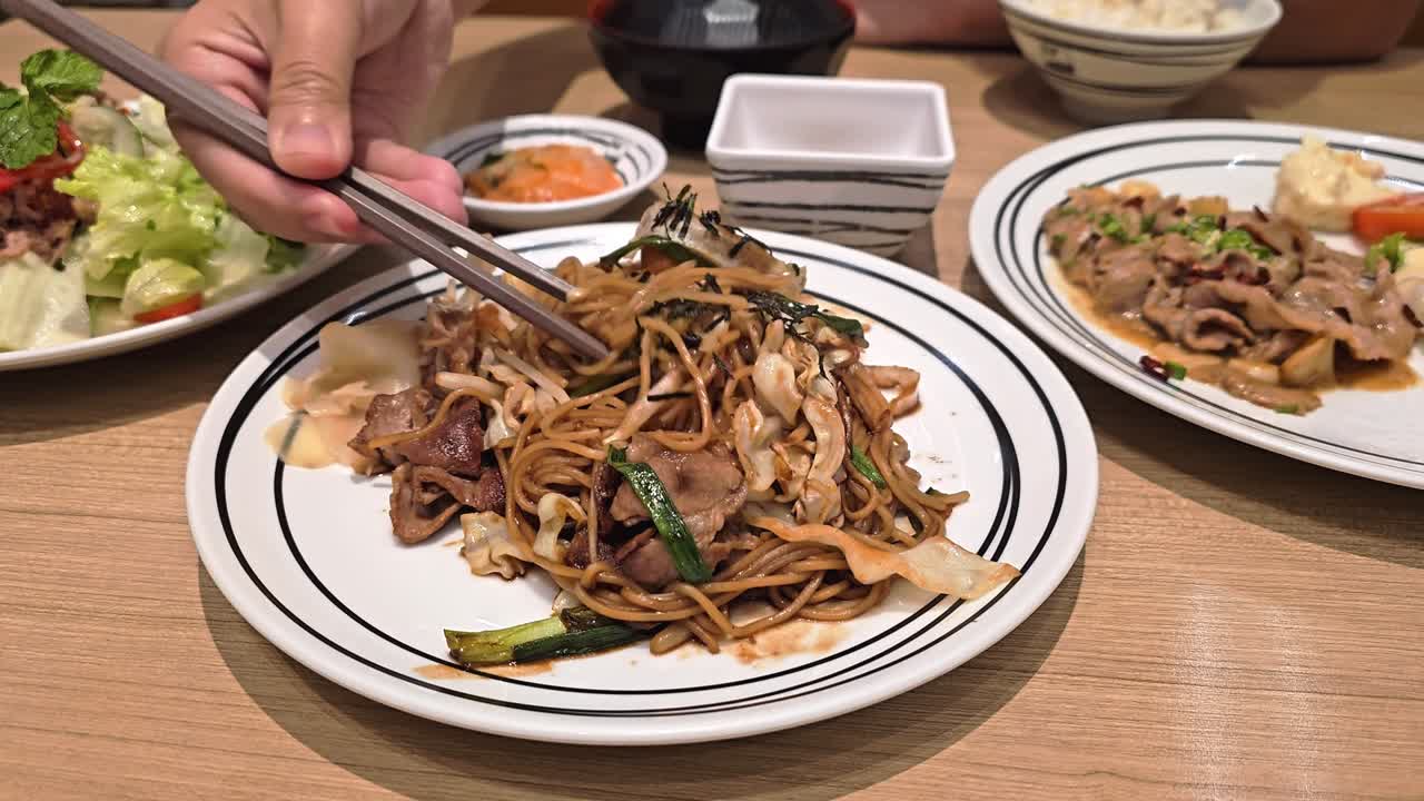 A vibrant plate of stir-fried noodles highlights culinary skills and flavors.