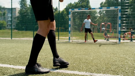 close up of soccer player's legs executing penalty kick and scoring a goal 1