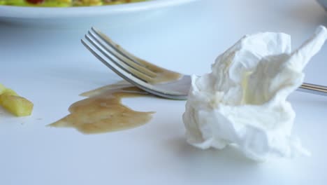 messy table setting after a meal with french fries and ketchup