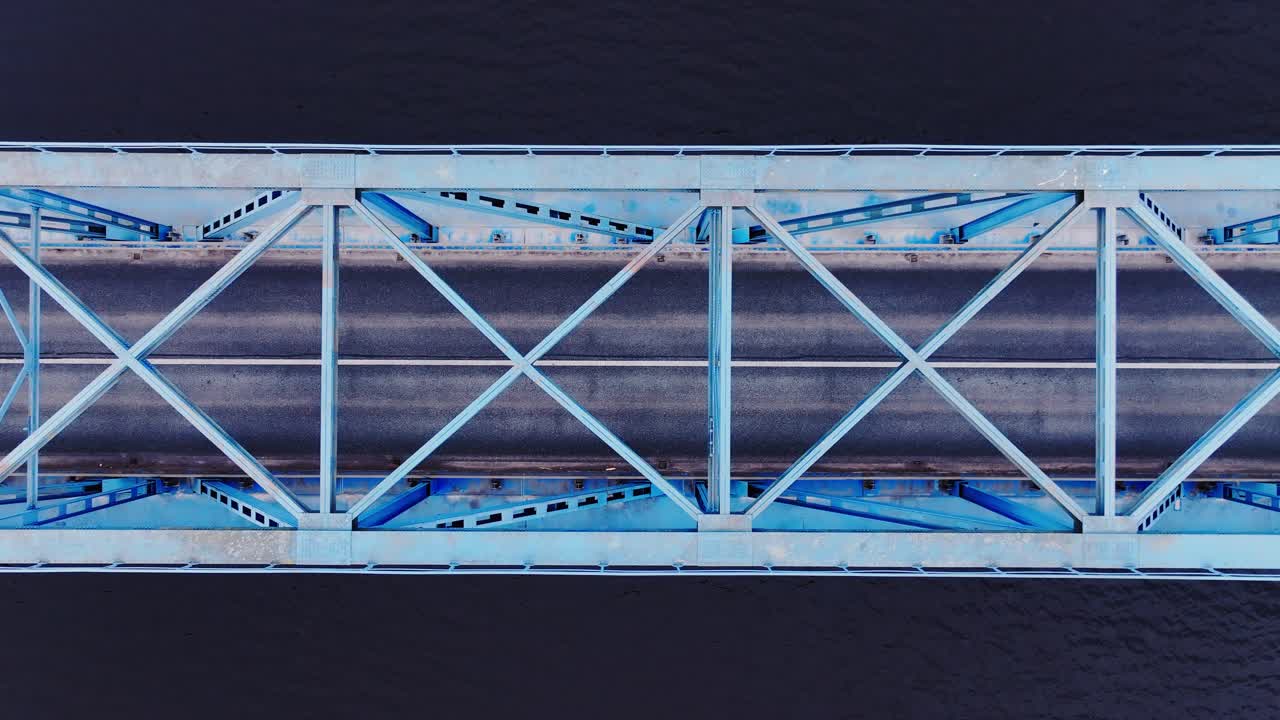 Smooth top down aerial glide reveals bold geometry of steel bridge design