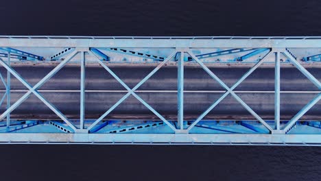 smooth top down aerial glide reveals bold geometry of steel bridge design