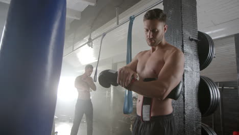men preparing for boxing training in gym