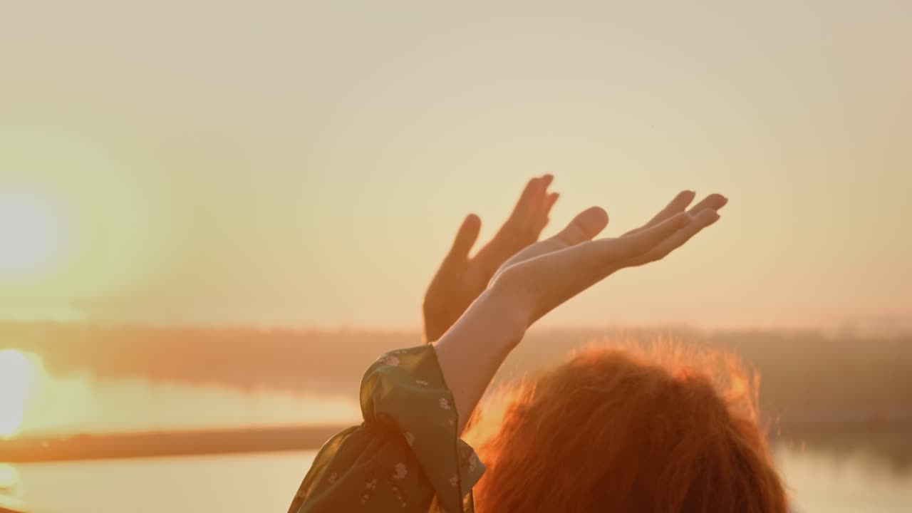 Hands Raised at Sunset