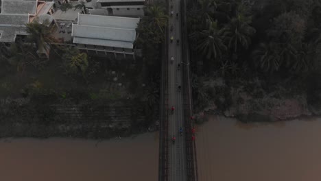 Top-down-view-of-bridge-at-luang-prabang-Laos-over-mekong-river,-aerial