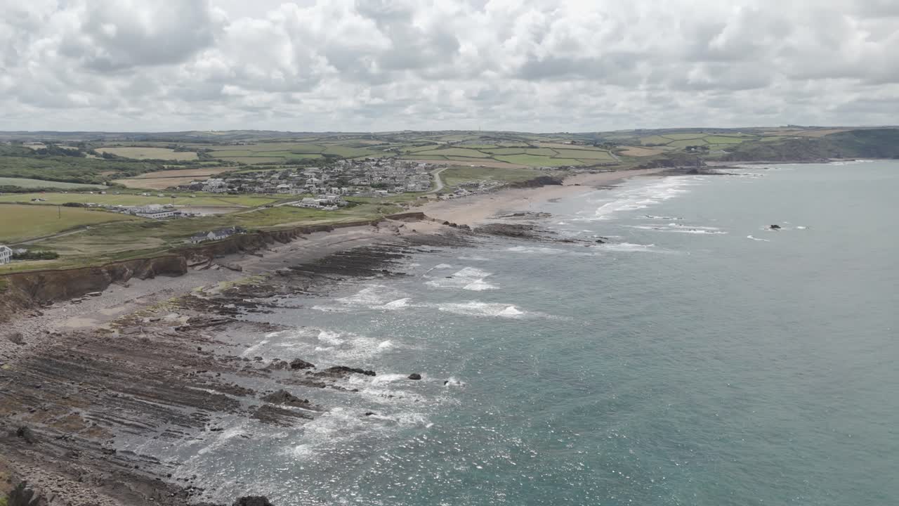 Aerial View of a Coastal Village and Rocky Beach