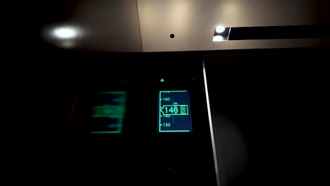 displaying speed and current floor, an led panel inside a modern elevator climbs upward, showcasing advanced technology in urban transportation