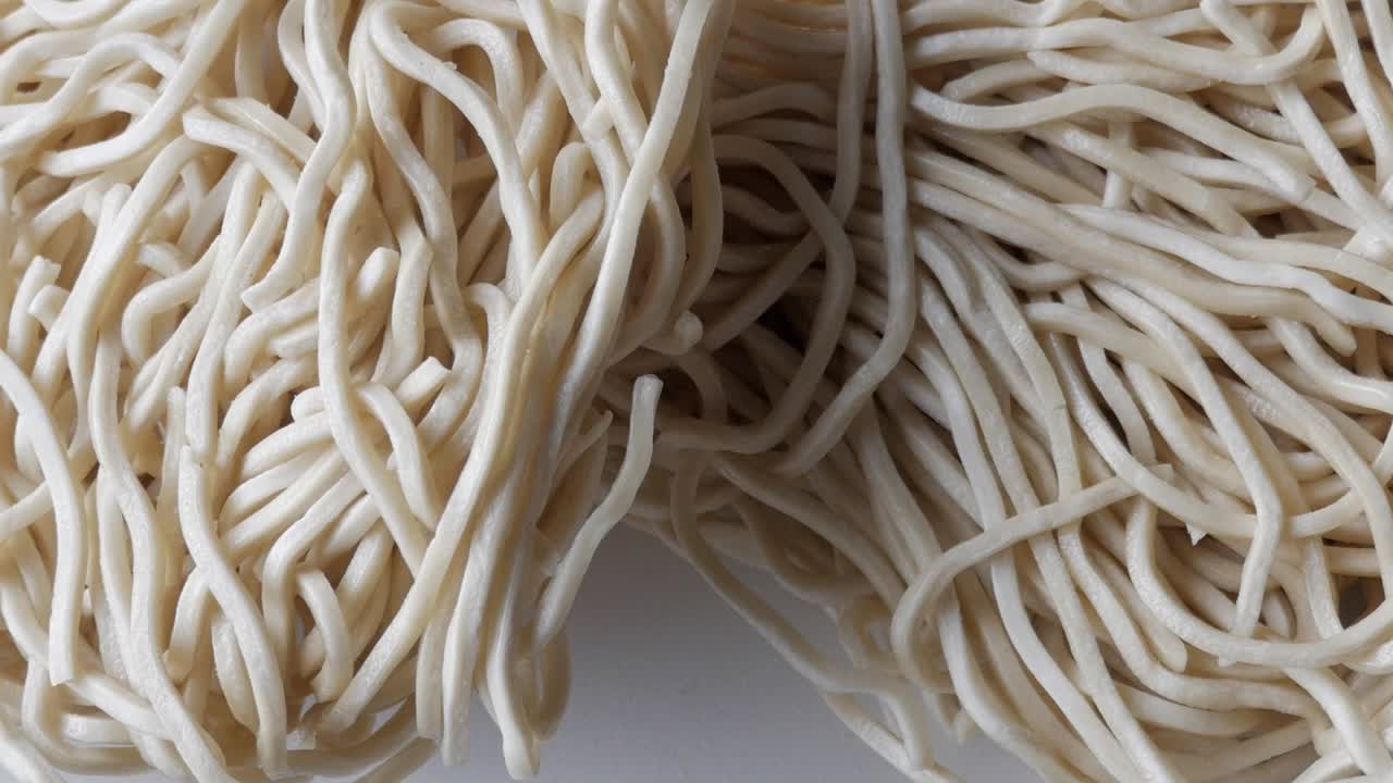 Close-up of wheat noodles tangled together in a heap, showing their texture