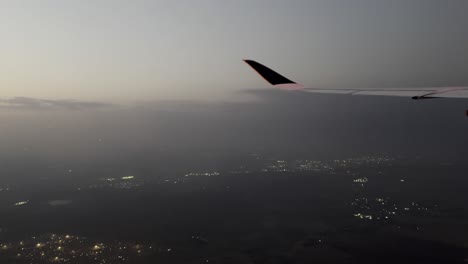 breathtaking 4k footage of land seen from an airplane window during sunrise