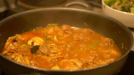 chicken curry cooking in a pan