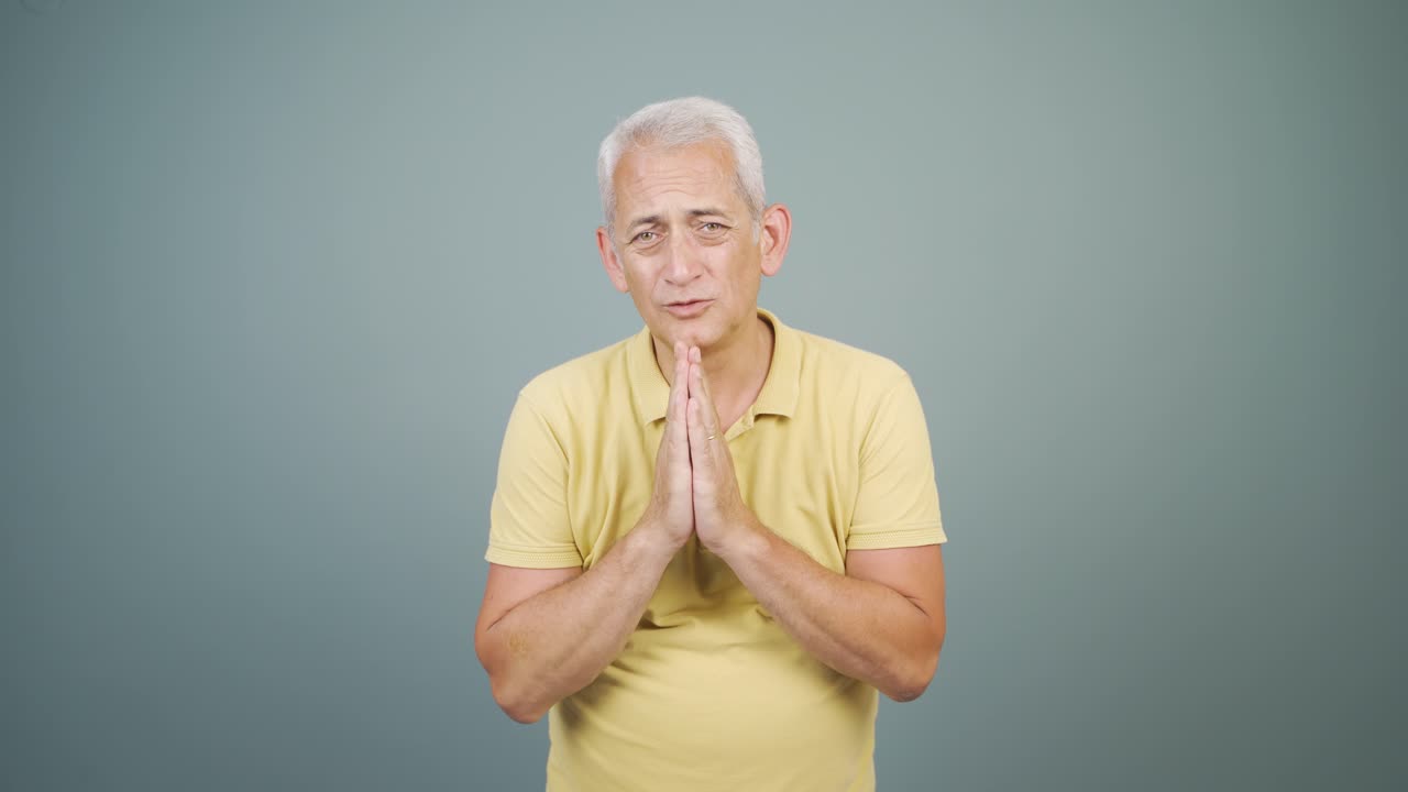 Man apologizing looking at camera.