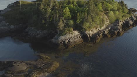 Up-and-to-the-right-to-reveal-lighthouse-and-ferry-from-below-tree-line