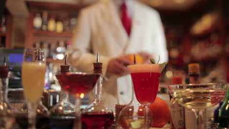 stylish waiter in cocktail bar