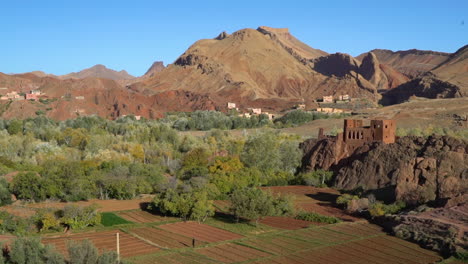 an establishing shot of a valley with castle or casbah in morocco