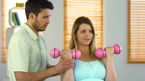 pregnant woman exercising with instructor