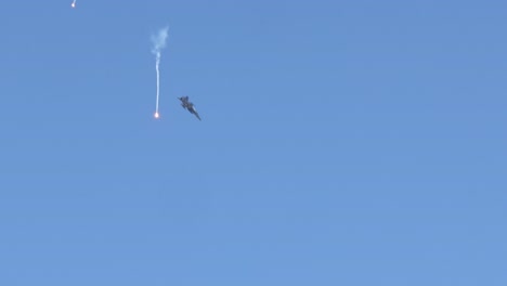 skydivers in freefall with smoke trails against blue sky