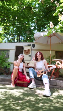 two friends enjoying music outdoors