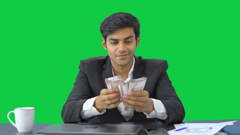 Indian-entrepreneur-counting-money-with-cunning-smile-Green-screen