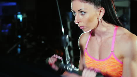 determination and motivation athletic woman at the gym trains hands female bodybuilding slow motion
