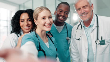 group of smiling doctors and nurses taking a selfie