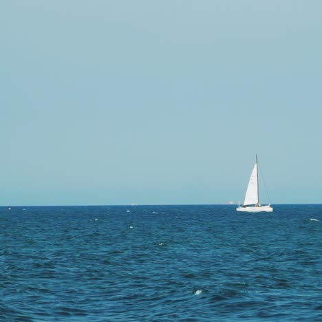 Yacht sailing on open sea at sunny day. Luxury yacht cruising at sea. Full open sails