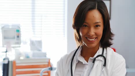 portrait of female doctor standing with arms crossed