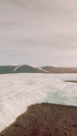 arctic glacier landscape: snow-covered mountains and frozen terrain