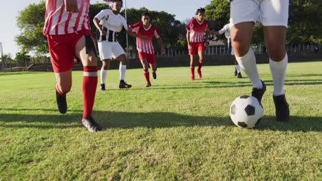 video of diverse group of male football player on field, playing football