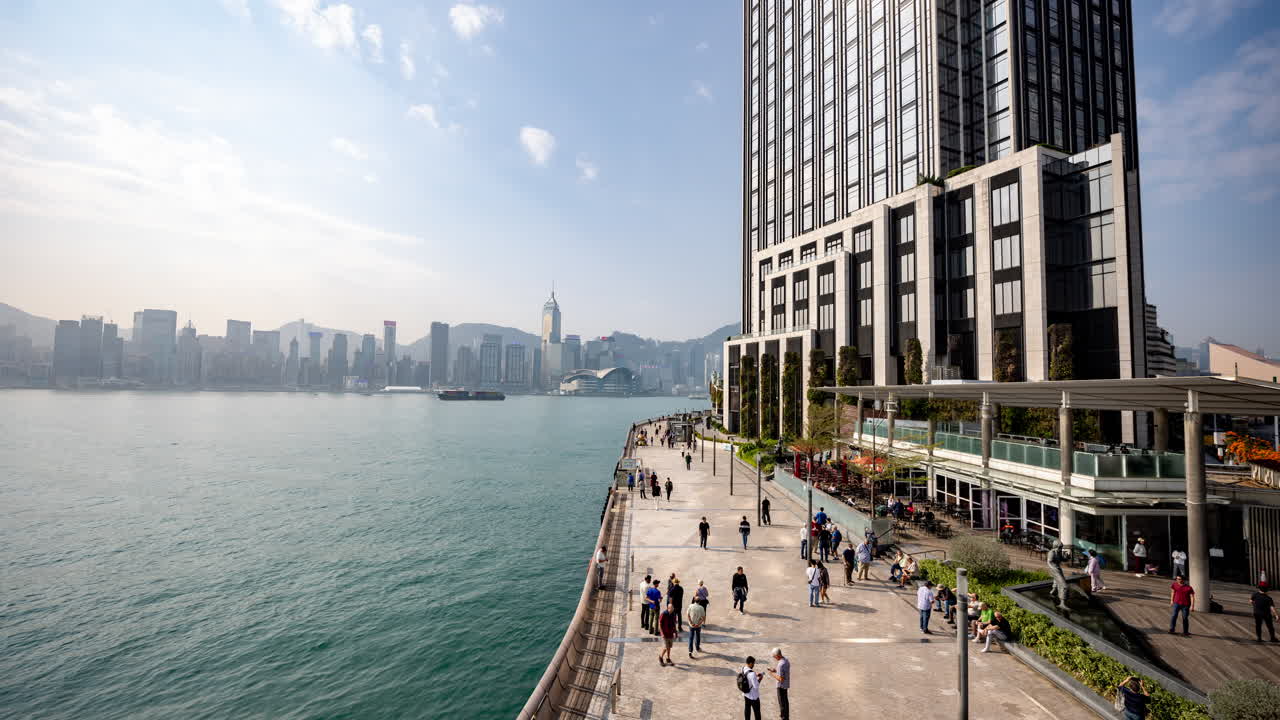 HONG KONG - 19 MARCH 2025 : Timelapse in the harbour waterfront in Kowloon, Hong Kong