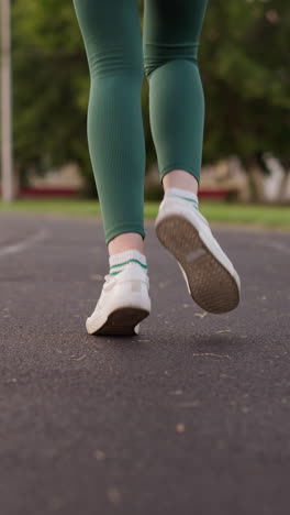 una mujer comienza a correr en el estadio local. una joven mantiene la salud haciendo ejercicio al aire libre. ejercicio para las piernas para aumentar la resistencia y la fuerza