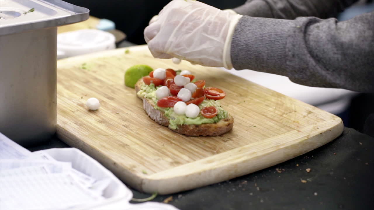 Preparing Gourmet Avocado Toast with Mozzarella and Tomatoes