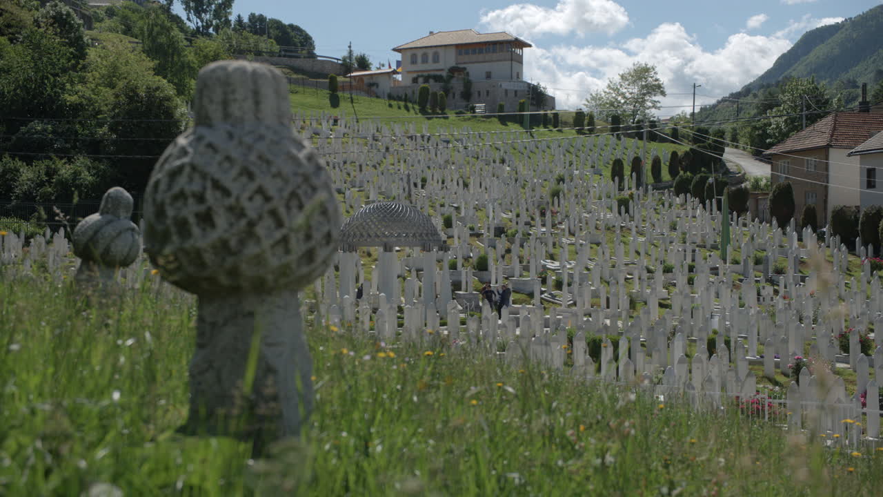 Rack focus from grave marker to wide view of Cemetary in Sarajevo, Bosnia.