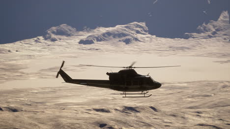 helicopter flying over desert mountains