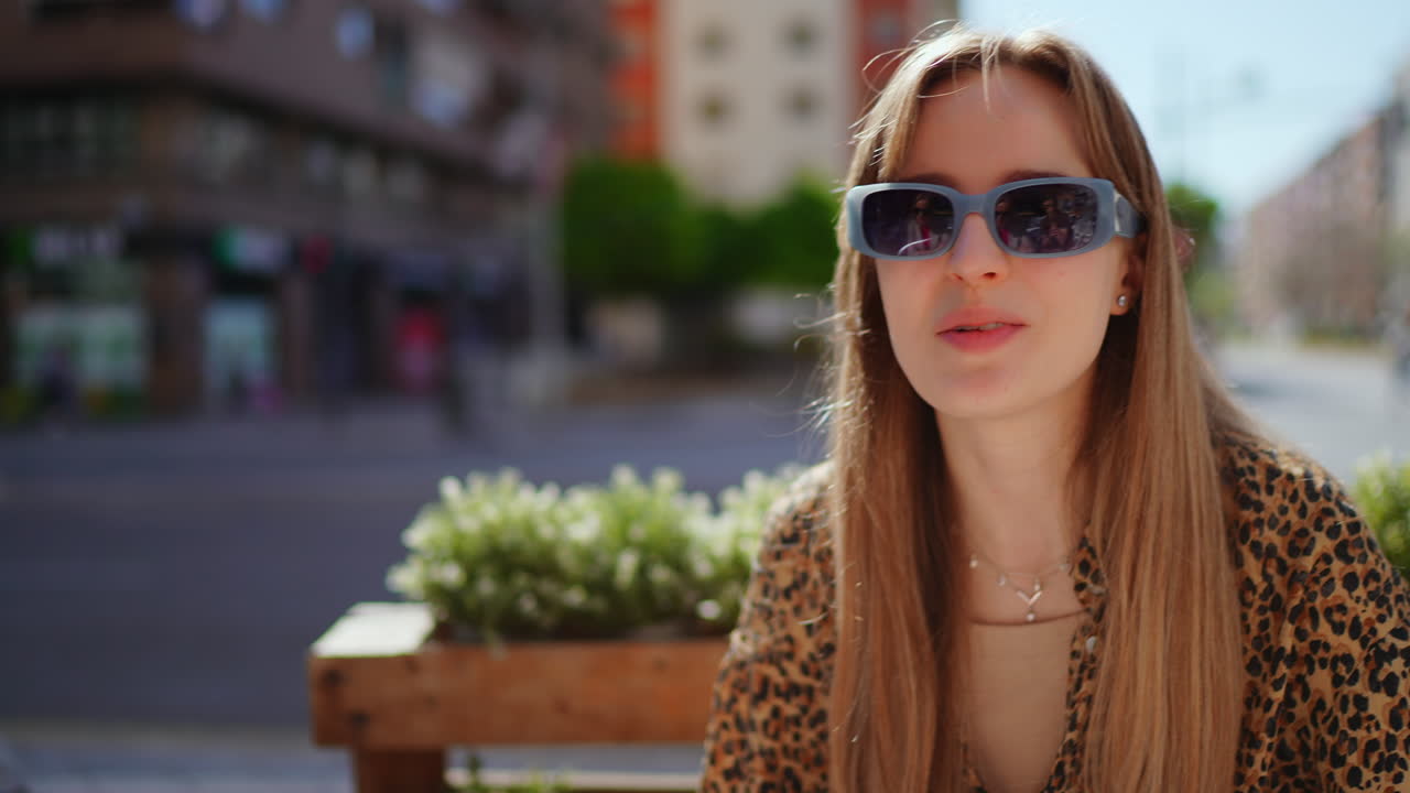 Woman in sunglasses at an outdoor cafe