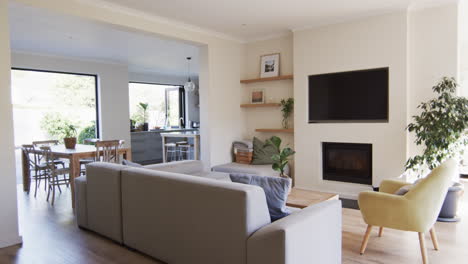 a spacious living room opens up to a dining area