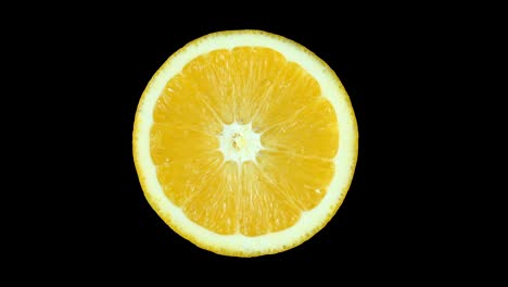 ripe orange fruit in the section slowly rotates around its axis. isolated on white background.