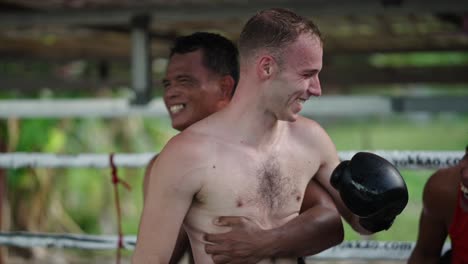 fighters training and laughing in a muay thai gym