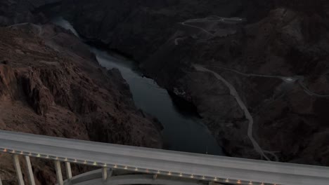 Aerial-drone-flies-over-memorial-bridge-colorado-river-night-dusk