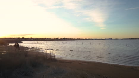 drone flying over the pink lake of torrevieja in alicante, spain at sunset