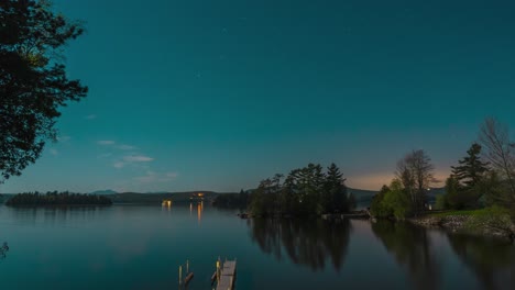 night time time lapse of secluded lake in new england with boat dock and full moon motion 4k 30p 30fps