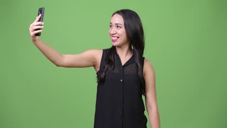 young beautiful asian businesswoman using phone