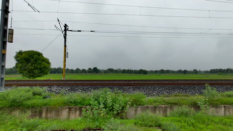 train tracks through lush green countryside