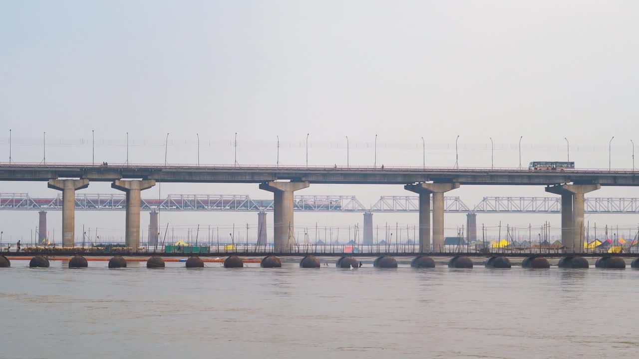 Railway and Road Bridge over Ganga or Ganges river with train and vehicles passing in Prayagraj or Allahabad in Uttar Pradesh India