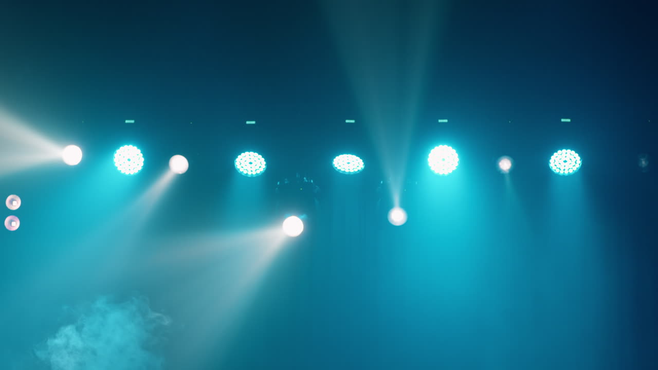 Dynamic Stage Lights with Blue and White Beams in Smoke