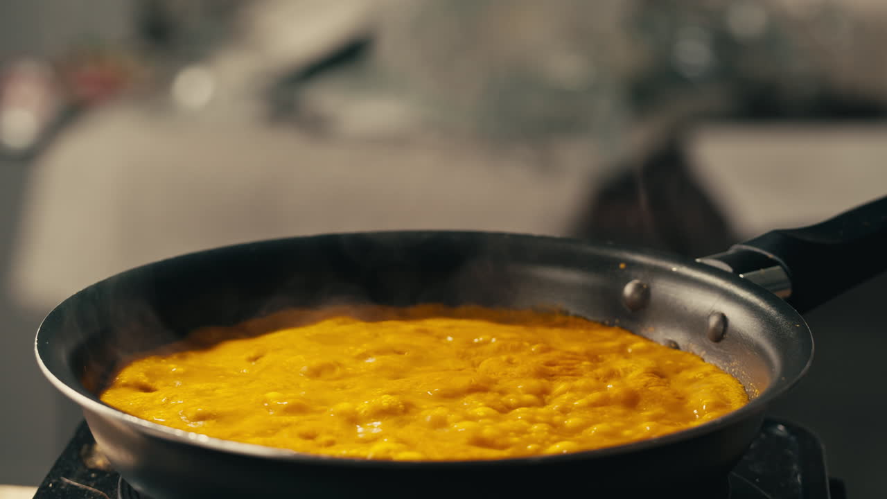 Yellow boiling sauce on pan close-up. Asian cuisine concept. Curry is a dish with a sauce seasoned with spices. Curries may contain fish, meat, poultry, or shellfish, either alone or in combination with vegetables. Others are vegetarian.