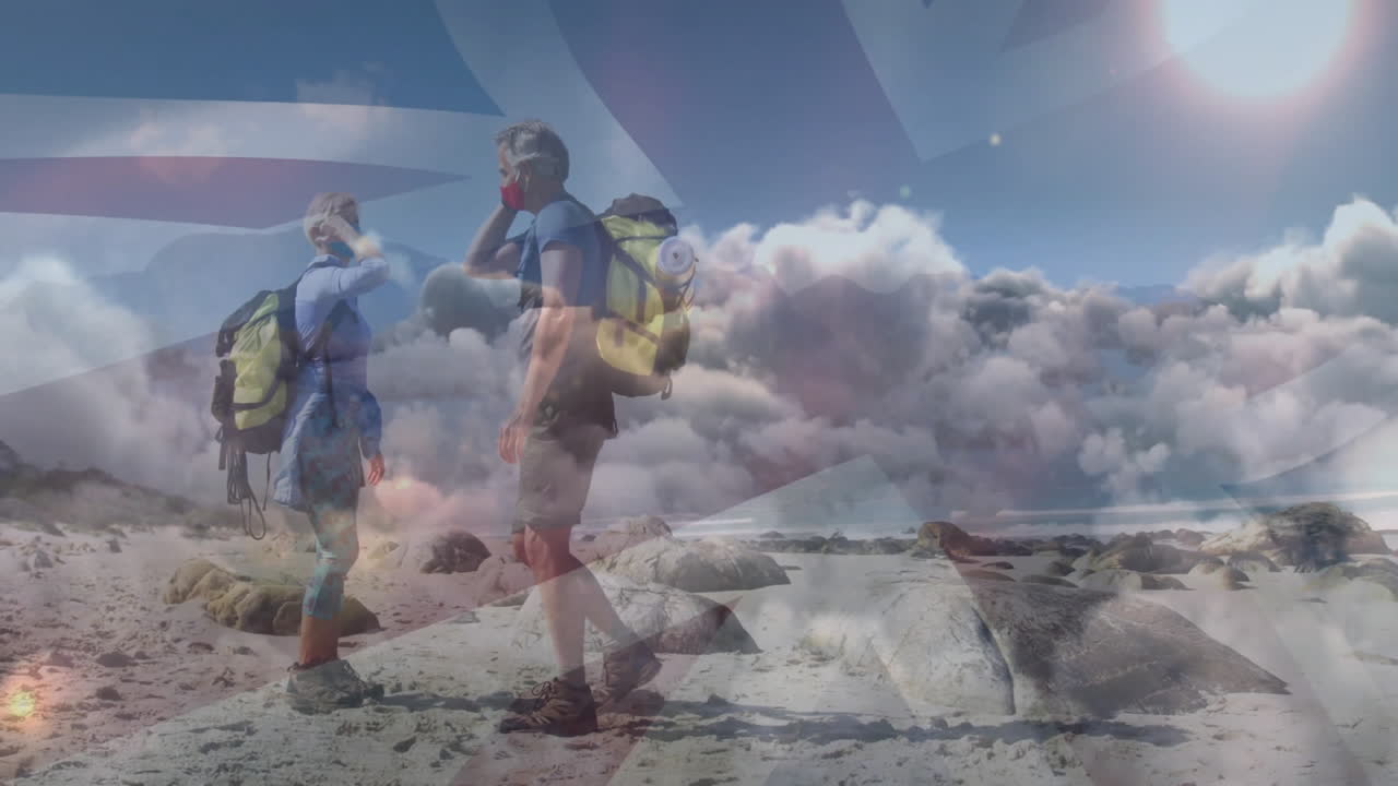 Man and woman hikers scanning rocky coastal beach under sun glare, with animated health data charts