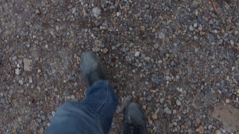 a person walks on a gravel path