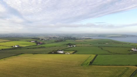 Coastal-agricultural-aerial-footage-of-Cork-county,-Ireland-on-a-summer-hazed-evening