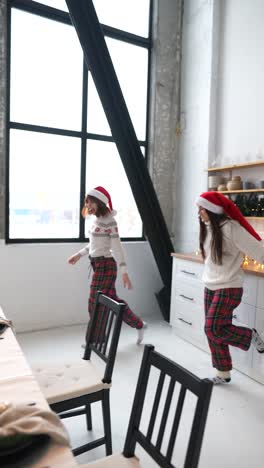 two women decorating christmas tree and opening presents