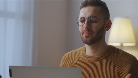 especialista masculino está hablando en una reunión en línea con colegas comunicándose con personas distantes de casa retrato de un hombre en la habitación